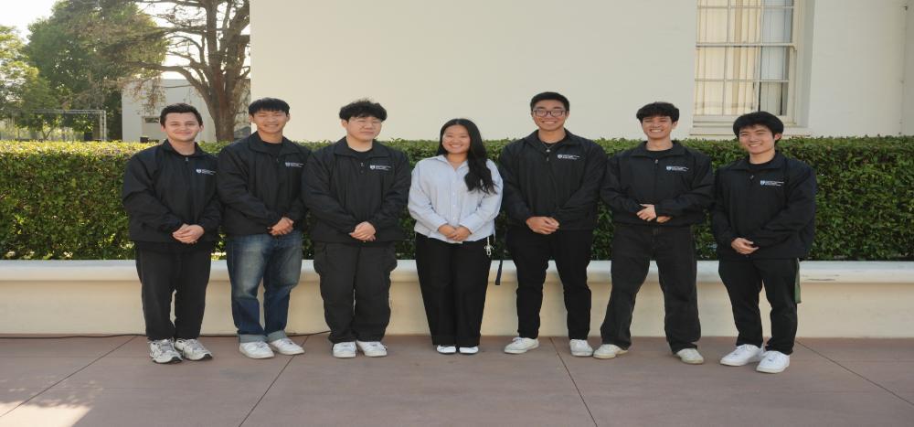 A group of students lined up with the Director of APSS in the middle